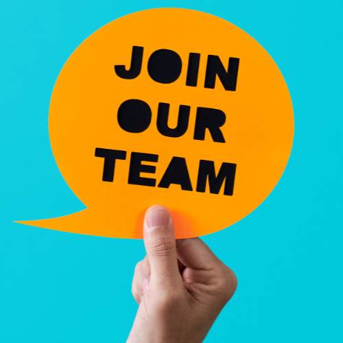 image of hand holding a paper speech bubble with the words "join our team" written on it